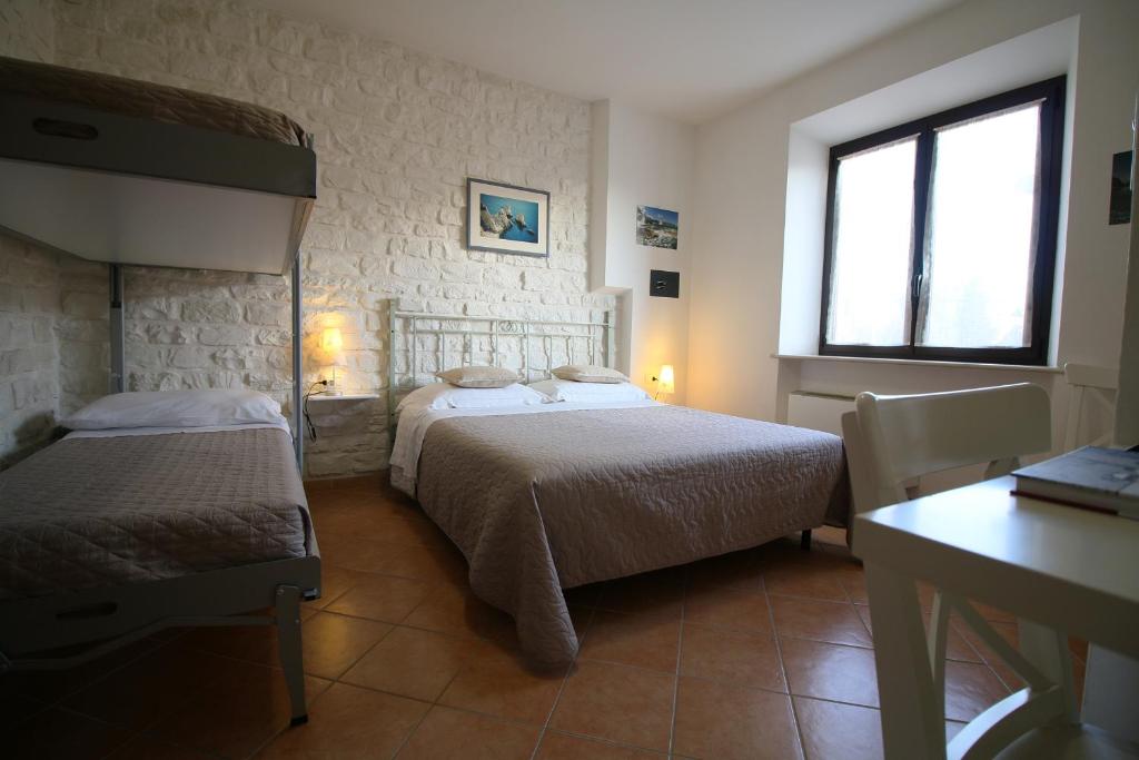 Postel nebo postele na pokoji v ubytování Conero Camere