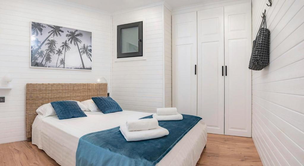 a bedroom with a bed with two towels on it at Parrot’s House in Lloret de Mar