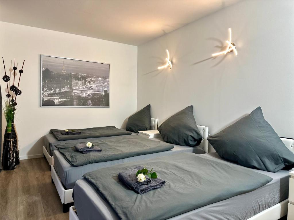 a bedroom with two beds and a painting on the wall at Apartment 3 in Pulheim