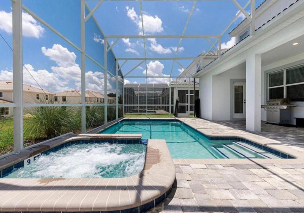 a swimming pool in the backyard of a house at Stunning Home wPrivate Pool, minutes from Disney in Davenport