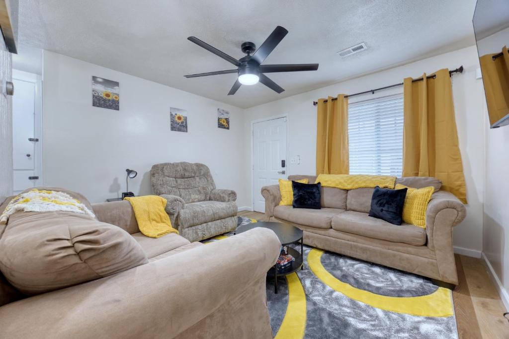 a living room with two couches and a ceiling fan at Southern Charm 3-0 in Columbus