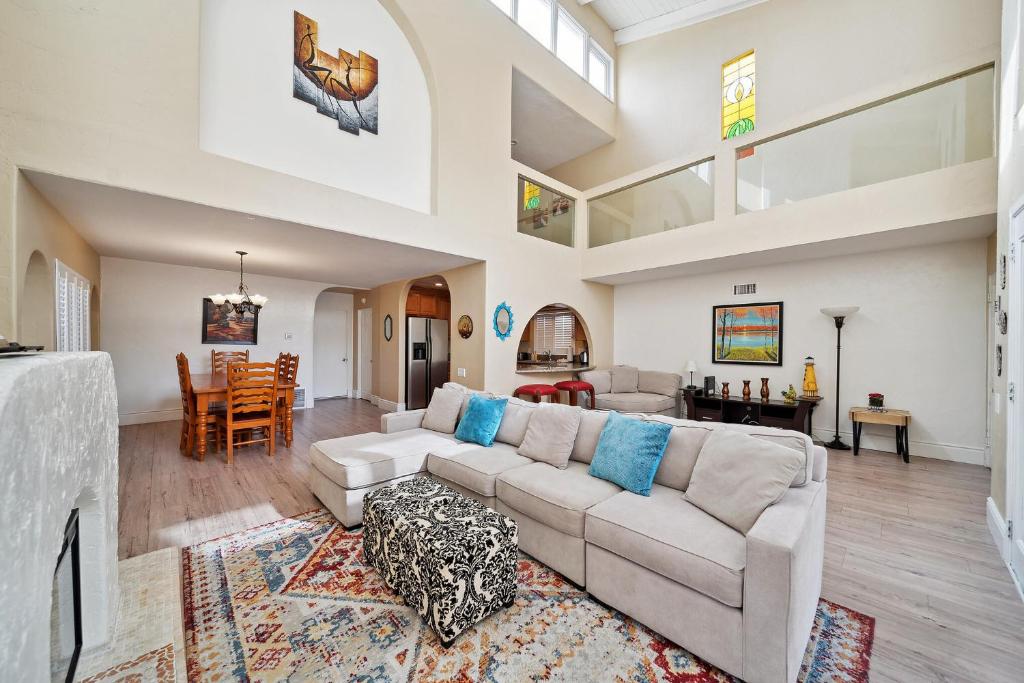 a living room with a couch and a dining room at Coastal Pet Friendly Gem Near the Beach and Shopping in Newport Beach