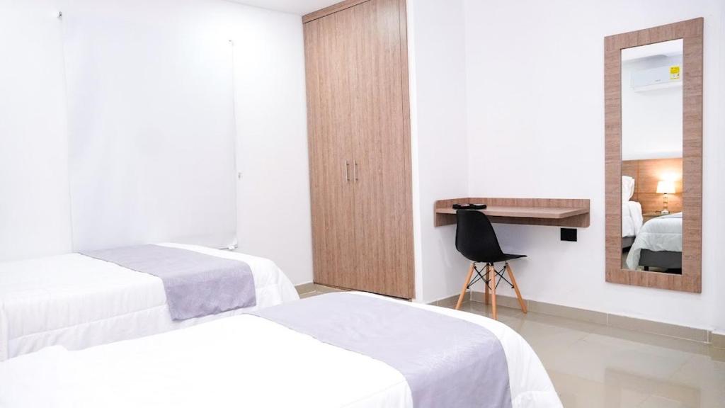 Letto o letti in una camera di Hotel Olam Deluxe Valledupar