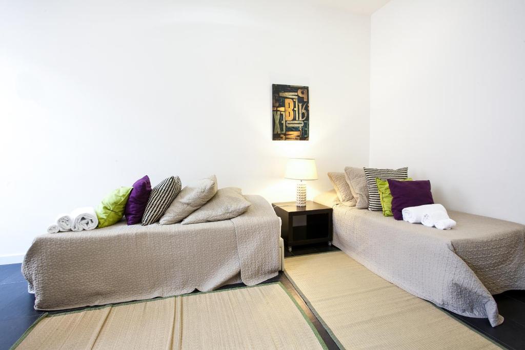 Postel nebo postele na pokoji v ubytování Downtown Apartments Bica