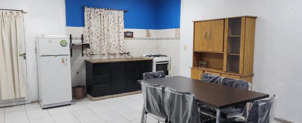 a kitchen with a table and a refrigerator at Casa Cepeda in Colón