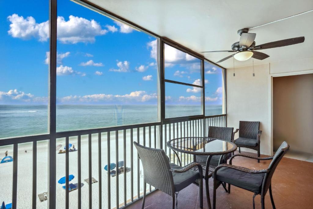 a balcony with a table and chairs and the ocean at Villa Madeira 505 - Premier in St. Pete Beach
