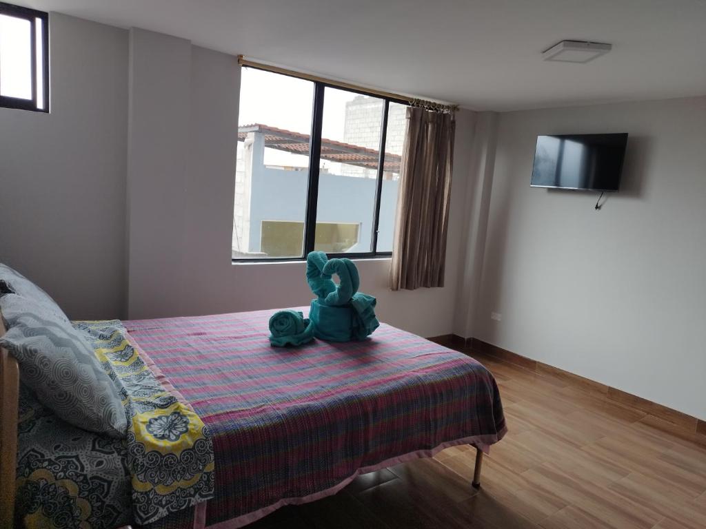 Postel nebo postele na pokoji v ubytování Hostal Terranova Quitumbe