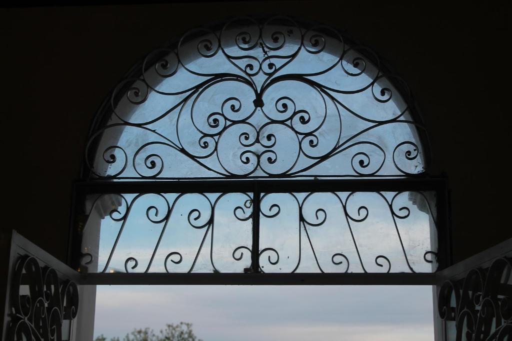 a window with a metal gate in a room at Epoca Iquitos in Iquitos