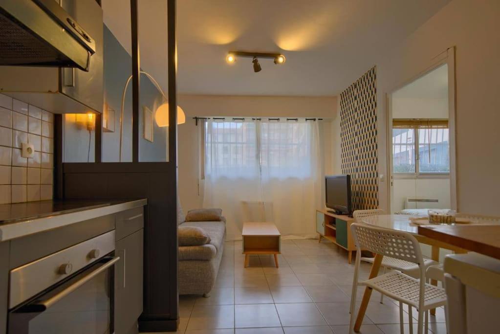 une cuisine et un salon avec un canapé et une table dans l'établissement Charmant Appartement, En Plein Centre , Face à la Gare Centrale, NICE CENTRE, à Nice