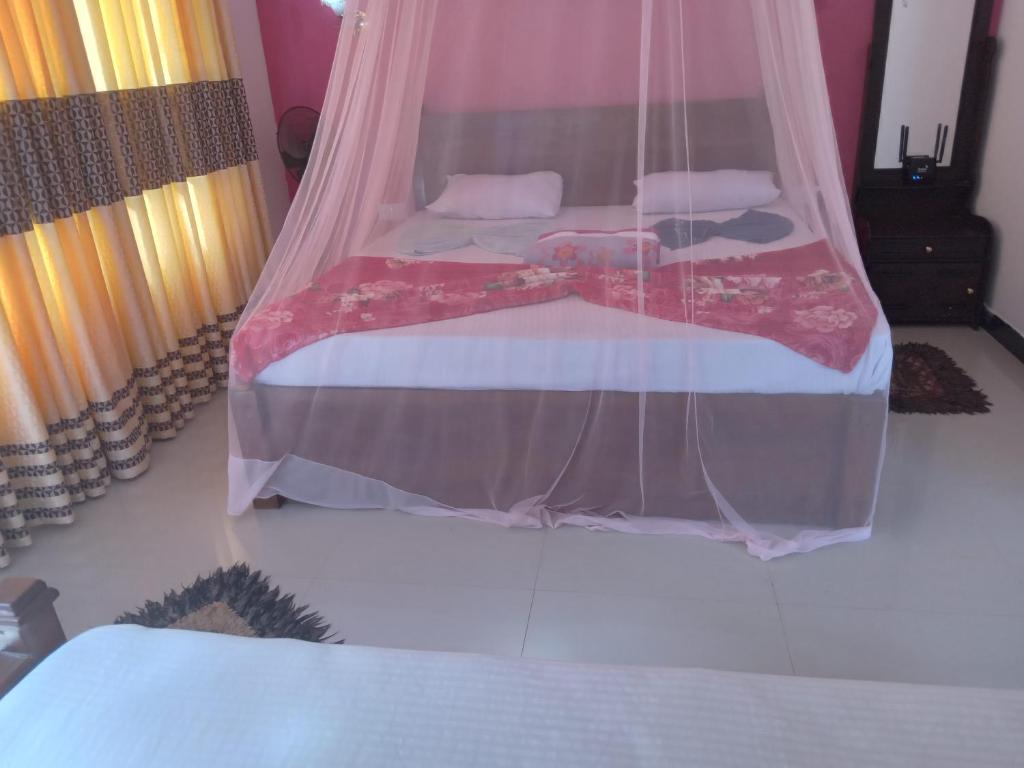 Postel nebo postele na pokoji v ubytování Nine Arch Araliya Homestay