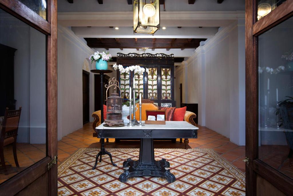 a living room with a table and a couch at Jawi Peranakan Mansion in George Town
