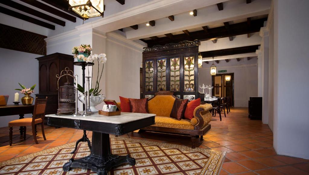 a living room with a couch and a table at Jawi Peranakan Mansion in George Town