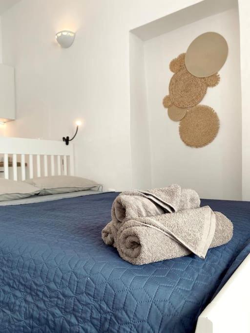 a bedroom with a bed with a towel on it at Artemonas Beige Escape in Sifnos