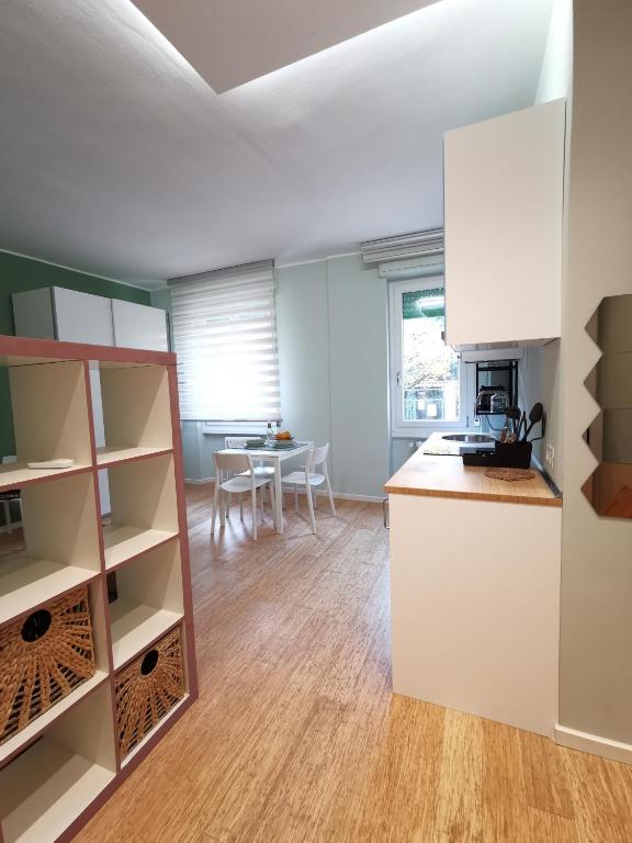 a kitchen with white cabinets and a table at Il Fico d'India in Bresso