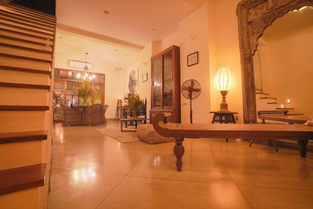 a living room with a mirror and a couch at The Merchant in Galle