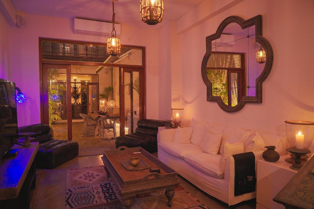 a living room with a white couch and a table at The Merchant in Galle
