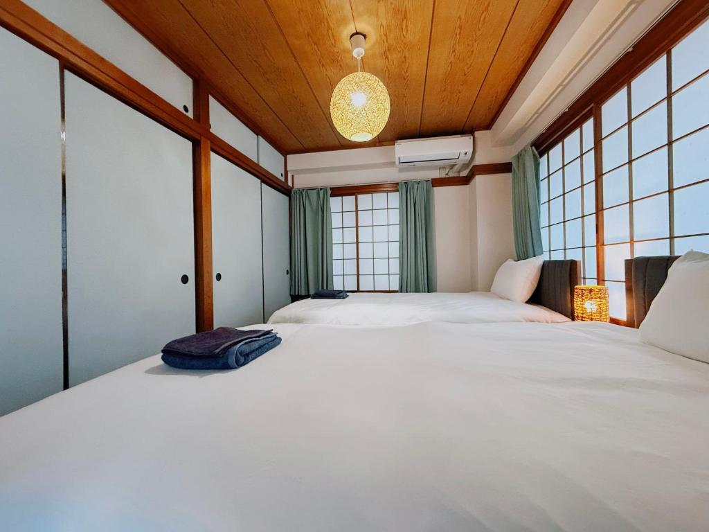 Postel nebo postele na pokoji v ubytování Tokyo Shinjuku Waseda House新宿早稲田