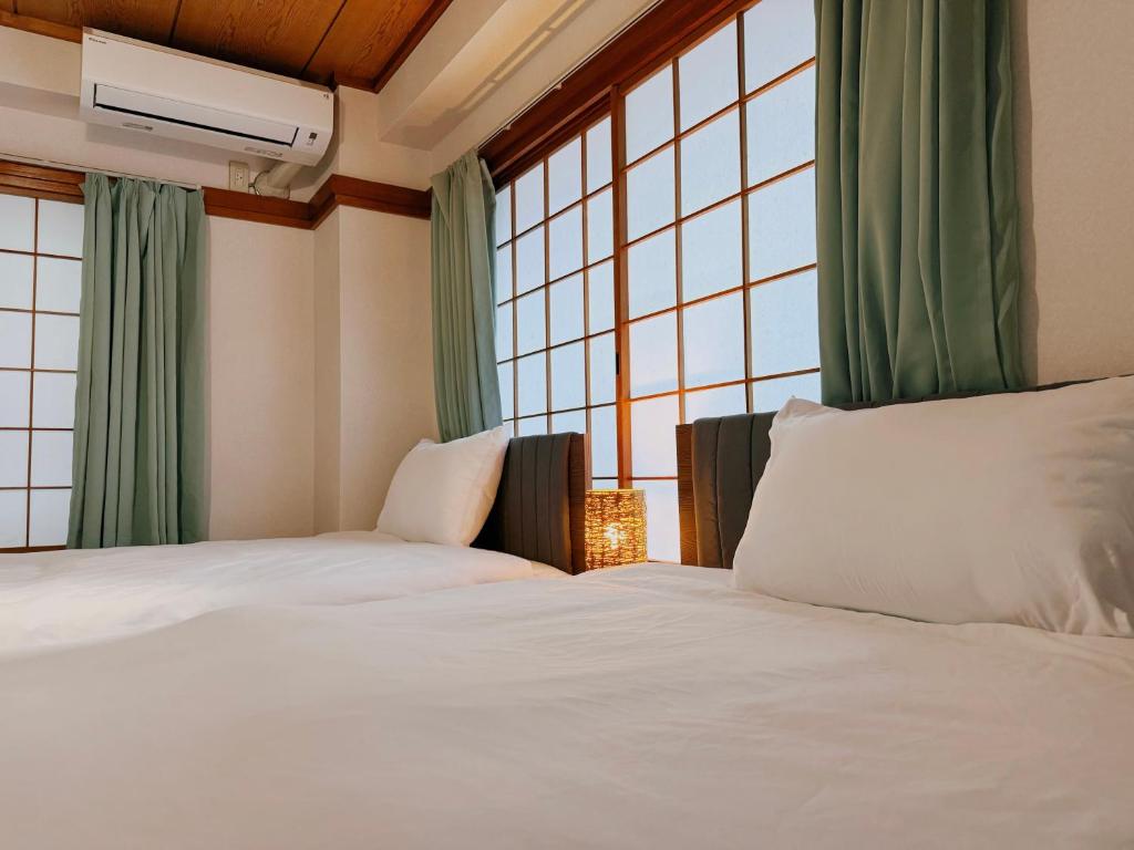 Postel nebo postele na pokoji v ubytování Tokyo Shinjuku Waseda House新宿早稲田