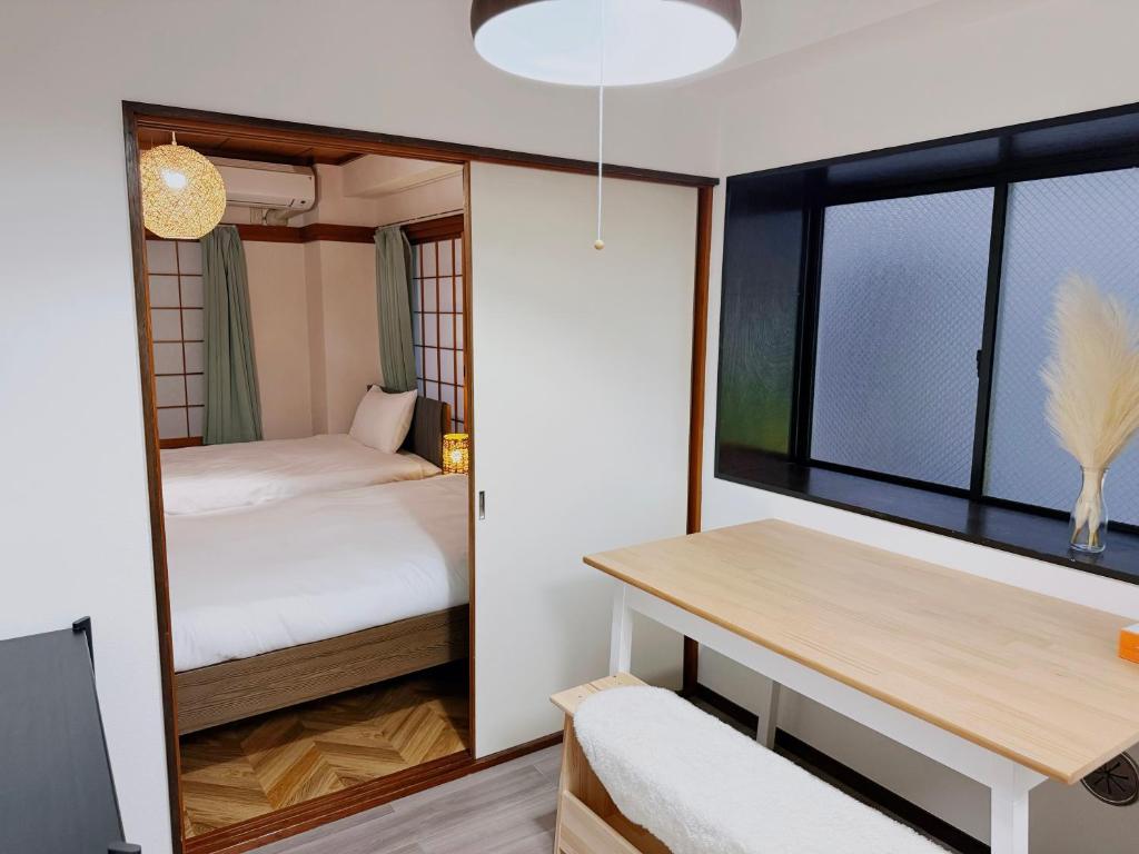 Postel nebo postele na pokoji v ubytování Tokyo Shinjuku Waseda House新宿早稲田