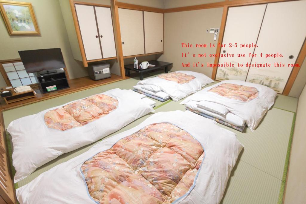 Postel nebo postele na pokoji v ubytování Ishicho