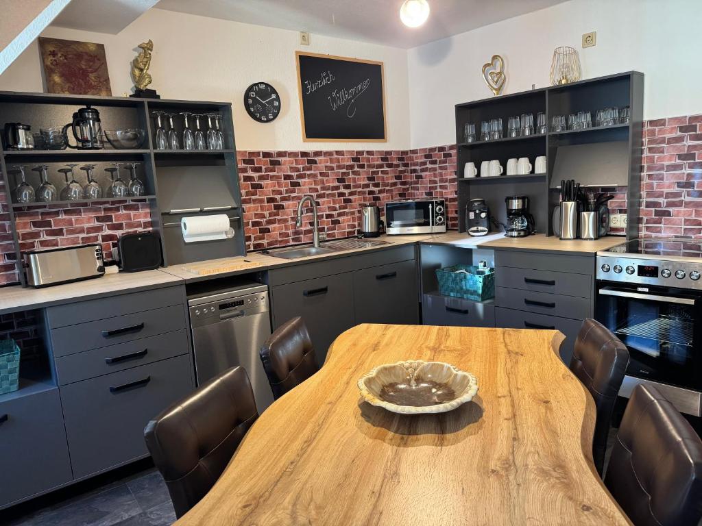 a large kitchen with a wooden table and chairs at Naumburger Charme Traminer in Naumburg
