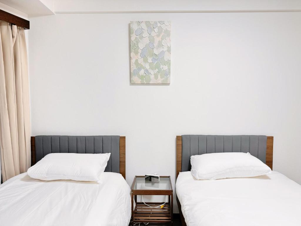 Postel nebo postele na pokoji v ubytování Tokyo Shinjuku Waseda House新宿早稲田