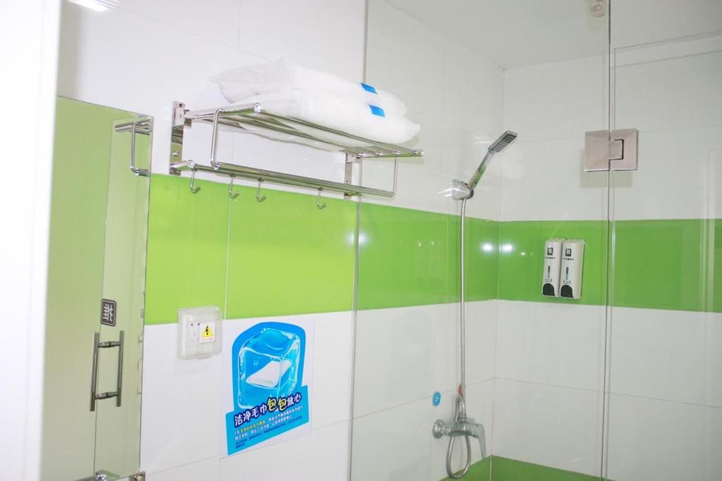 eine Dusche im Bad mit grünen und weißen Wänden in der Unterkunft 7Days Premium Yinchuan Railway Station Fuzhou South Street in Yinchuan