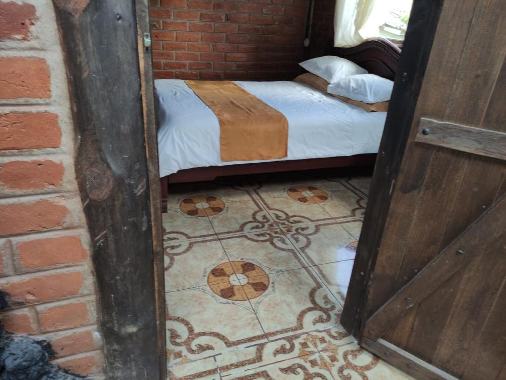 Postel nebo postele na pokoji v ubytování Hostería Las Orquídeas