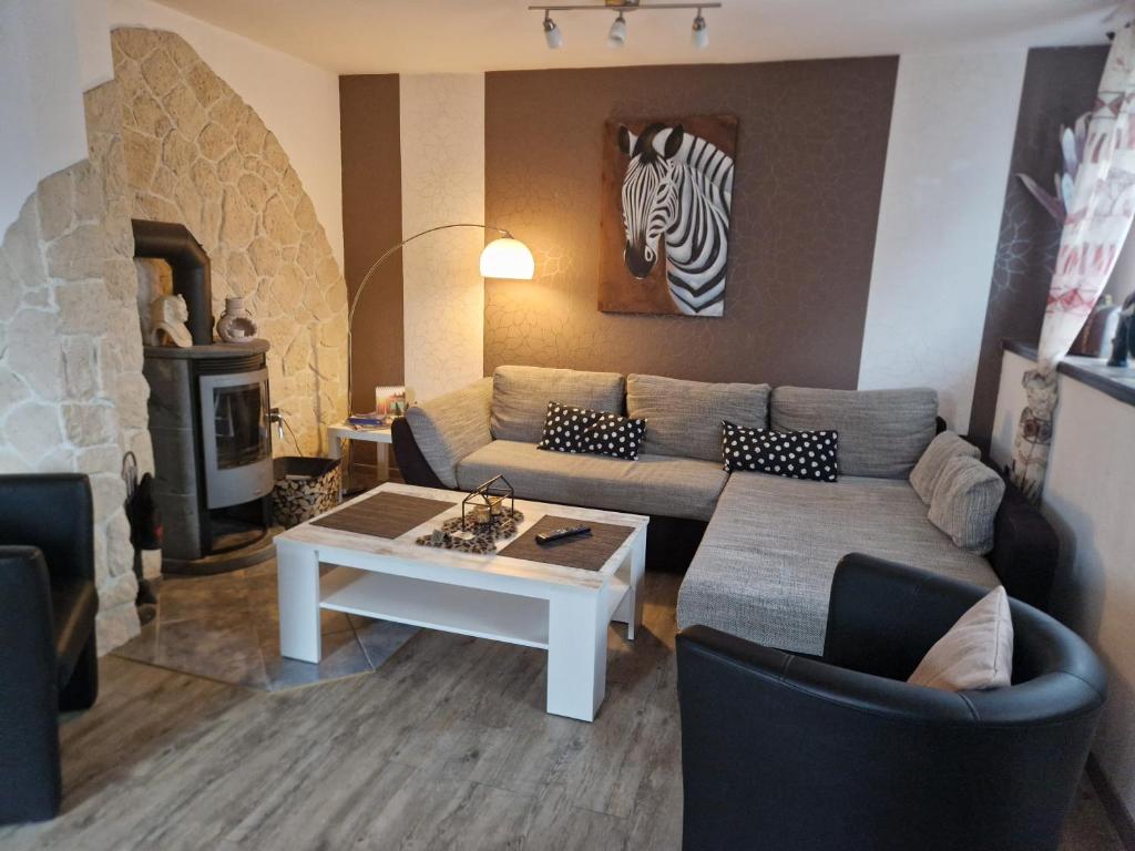a living room with a couch and a zebra picture on the wall at Ferienwohnung Parkblick Medebach in Medebach