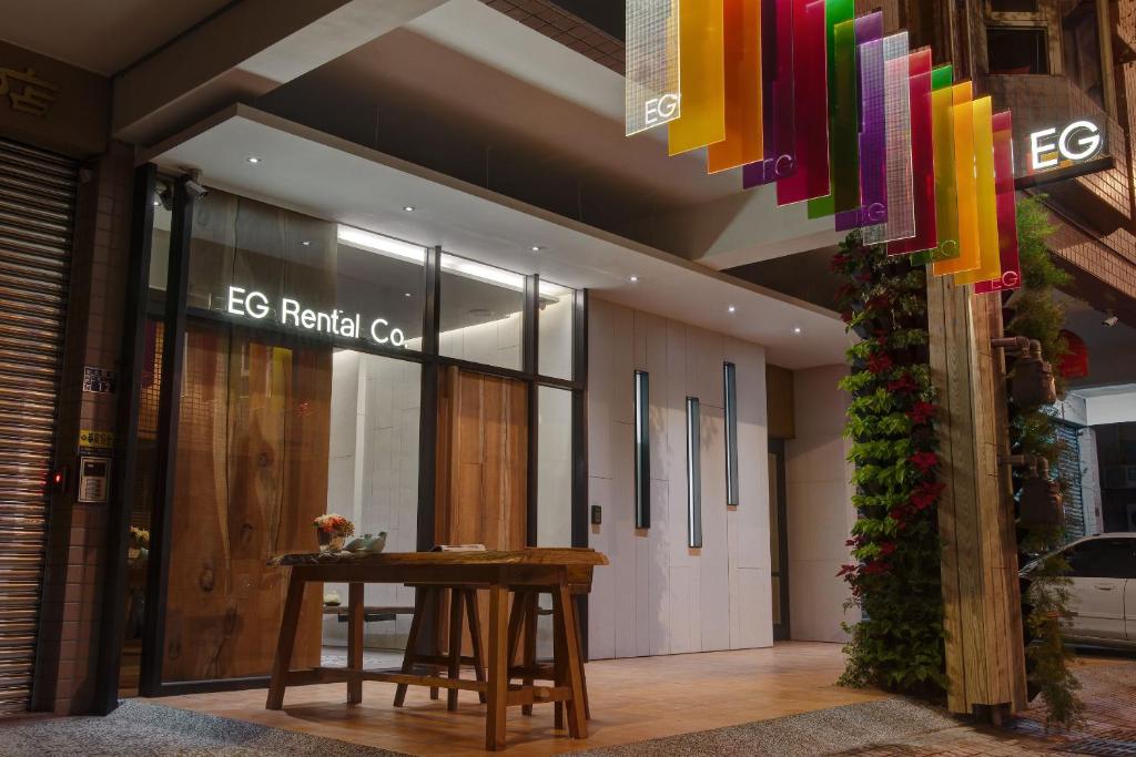 a store front with a wooden table in a building at EG Hostel in Nantou City