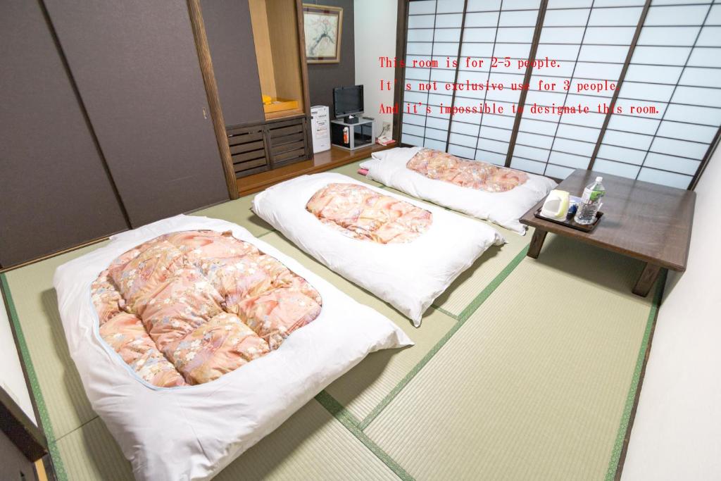 Postel nebo postele na pokoji v ubytování Ishicho