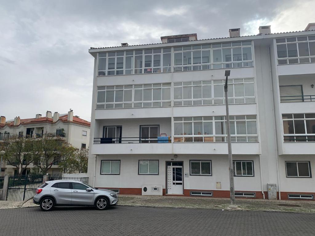 a car parked in front of a large building at Cozy Carcavelos Beach-NOVA SBE in Carcavelos