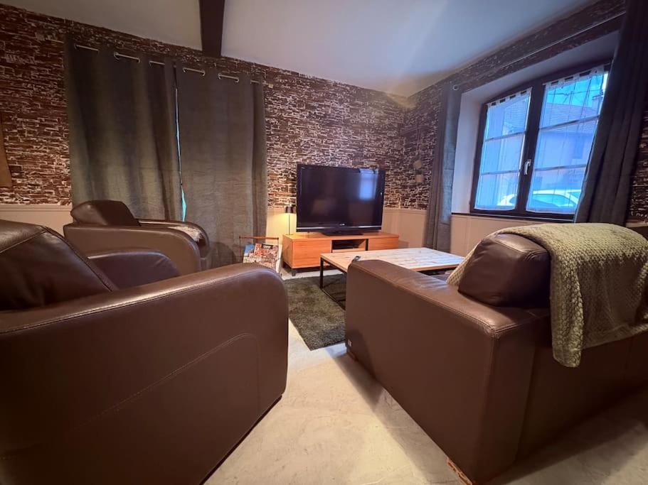 a living room with two couches and a flat screen tv at Chez Charles Meublé de Tourisme Trois Etoiles - Confort et Convivialité in Guémar
