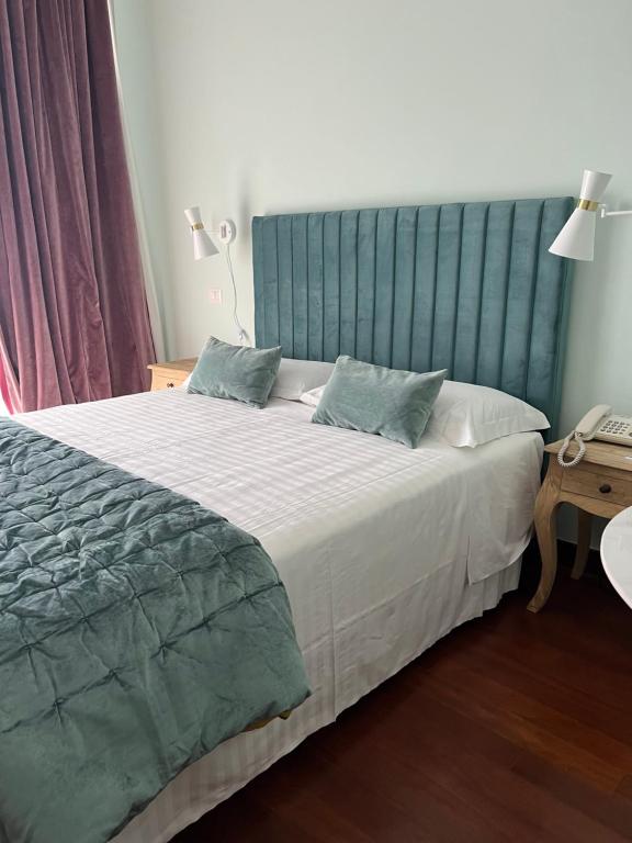 Postel nebo postele na pokoji v ubytování Hotel Fenix