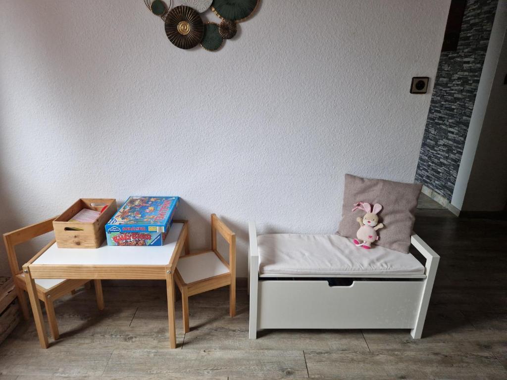 a room with two chairs and a chair with a stuffed animal at Ferienwohnung Parkblick Medebach in Medebach