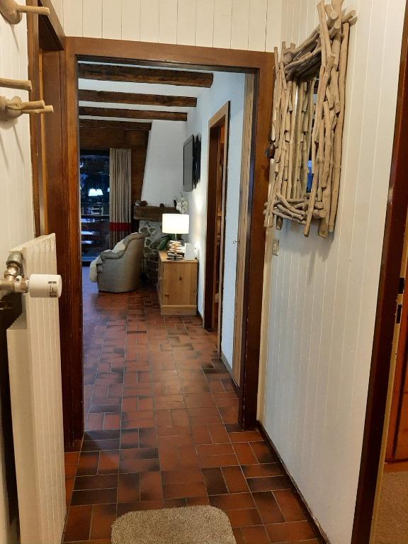 a hallway with a door leading to a living room at Chalet Taipan Verbier in Verbier