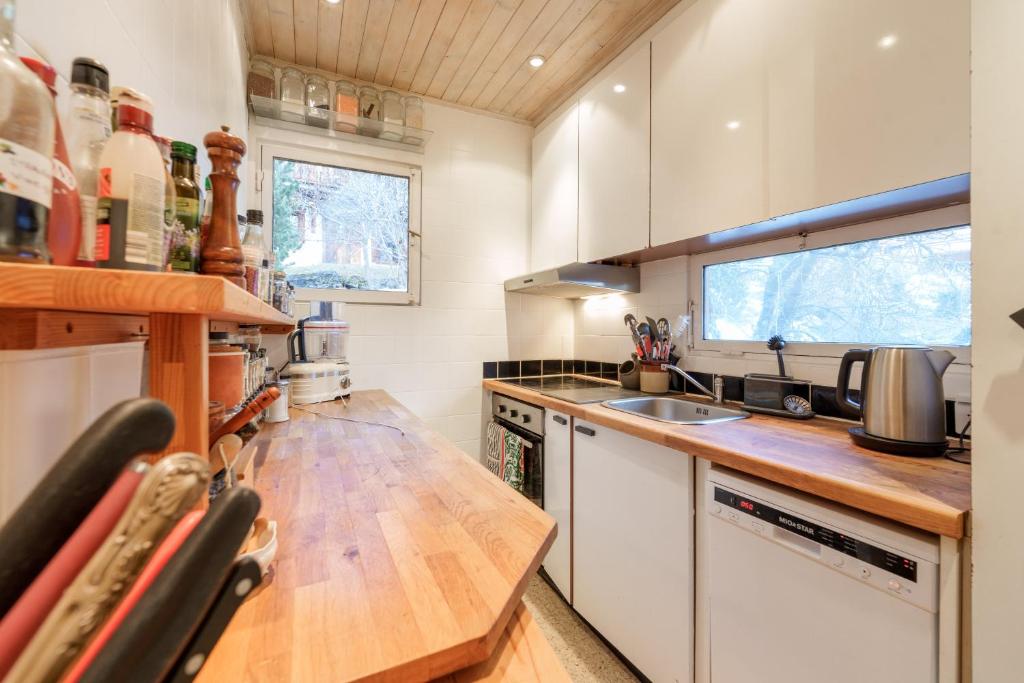 a kitchen with a wooden counter top and a sink at Chalet Taipan Verbier in Verbier