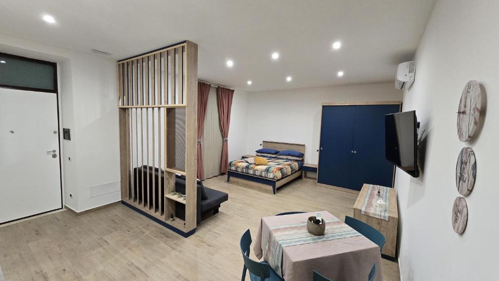 a living room with a couch and a table and a tv at Etruria Apartments Salerno in Salerno