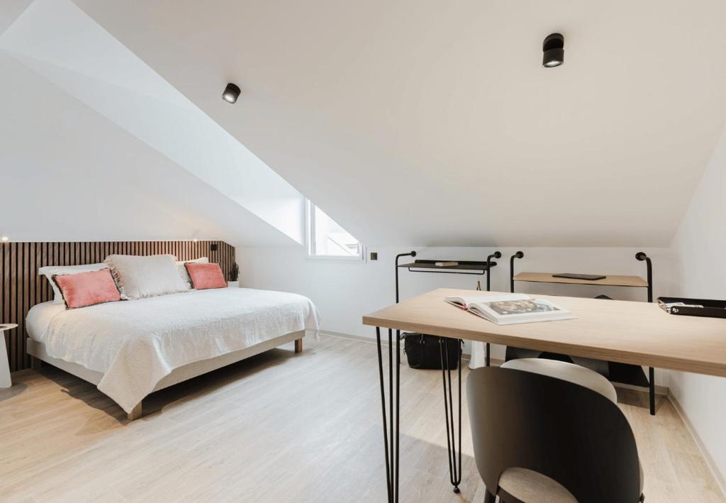 Postel nebo postele na pokoji v ubytování Appart Hotel Neostelia
