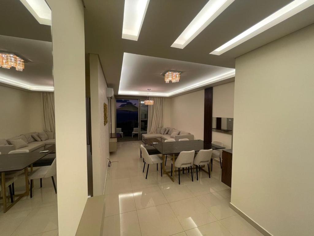 a dining room with tables and chairs in a building at Tabarja hills in ‘Ayn aş Şughayrah