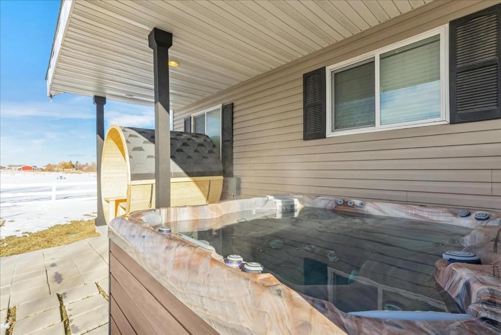 a hot tub on the side of a house at Private Hot Tub Sauna Prime Location in Garden City