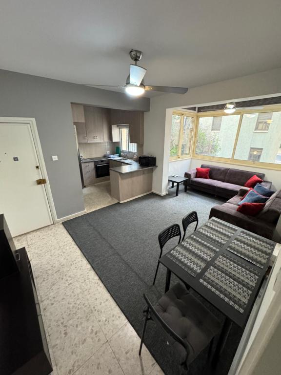 a living room with a couch and a table at Georges 2 Bedroom Apartment in Limassol
