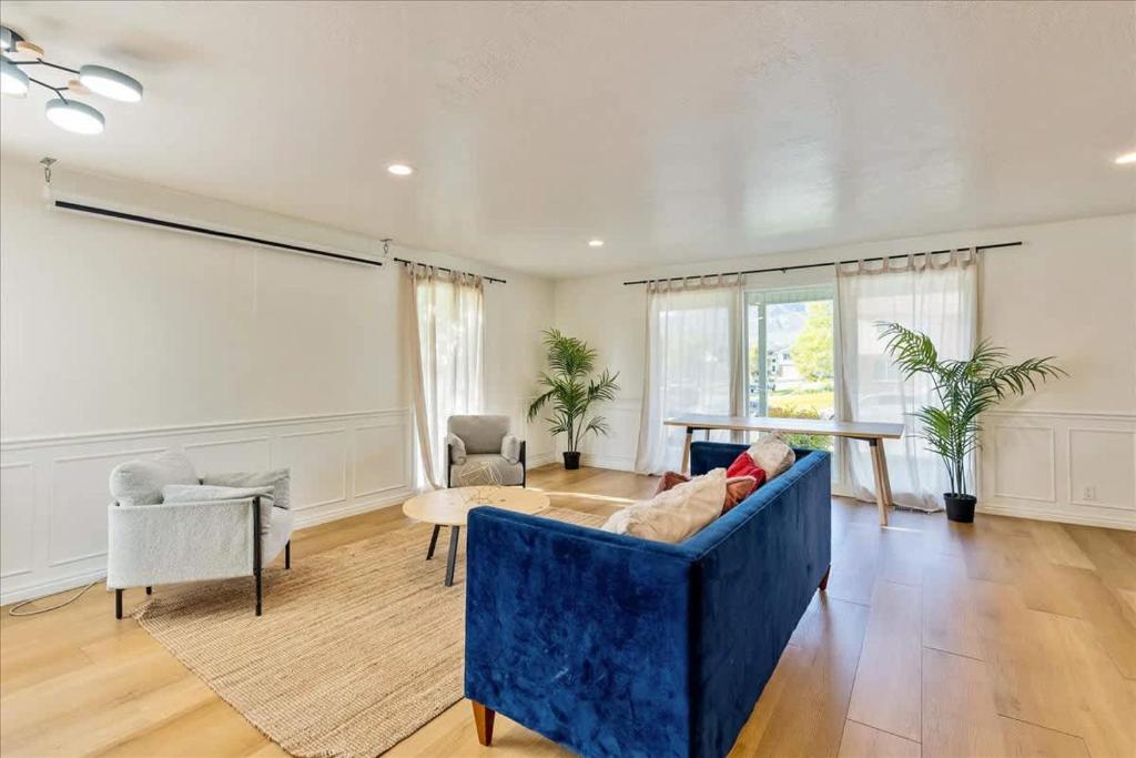 a living room with a blue couch and chairs at Central Location in Ogden Private Room & Bath in Ogden