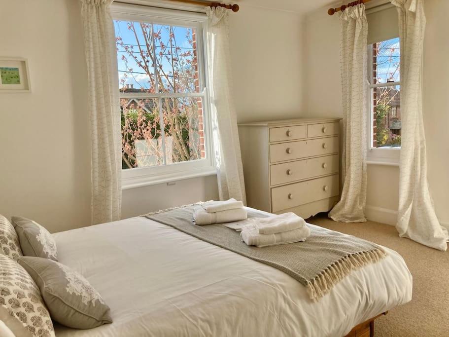 a bedroom with a bed with two towels on it at New Forest Cottage in Lyndhurst