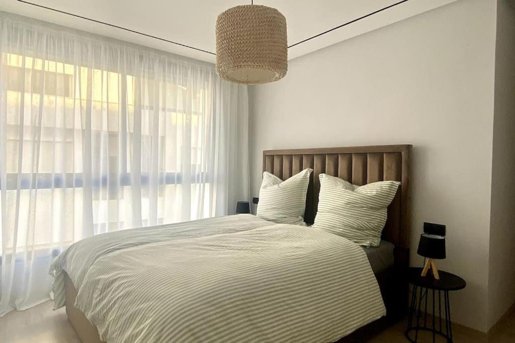 Ένα ή περισσότερα κρεβάτια σε δωμάτιο στο Appartement en résidence Malabata Hills