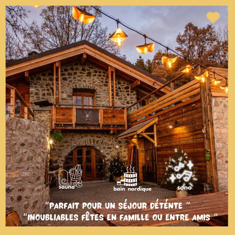 une publicité pour une maison en bois avec des lumières allumées dans l'établissement Le refuge des Toupins, à Prunières