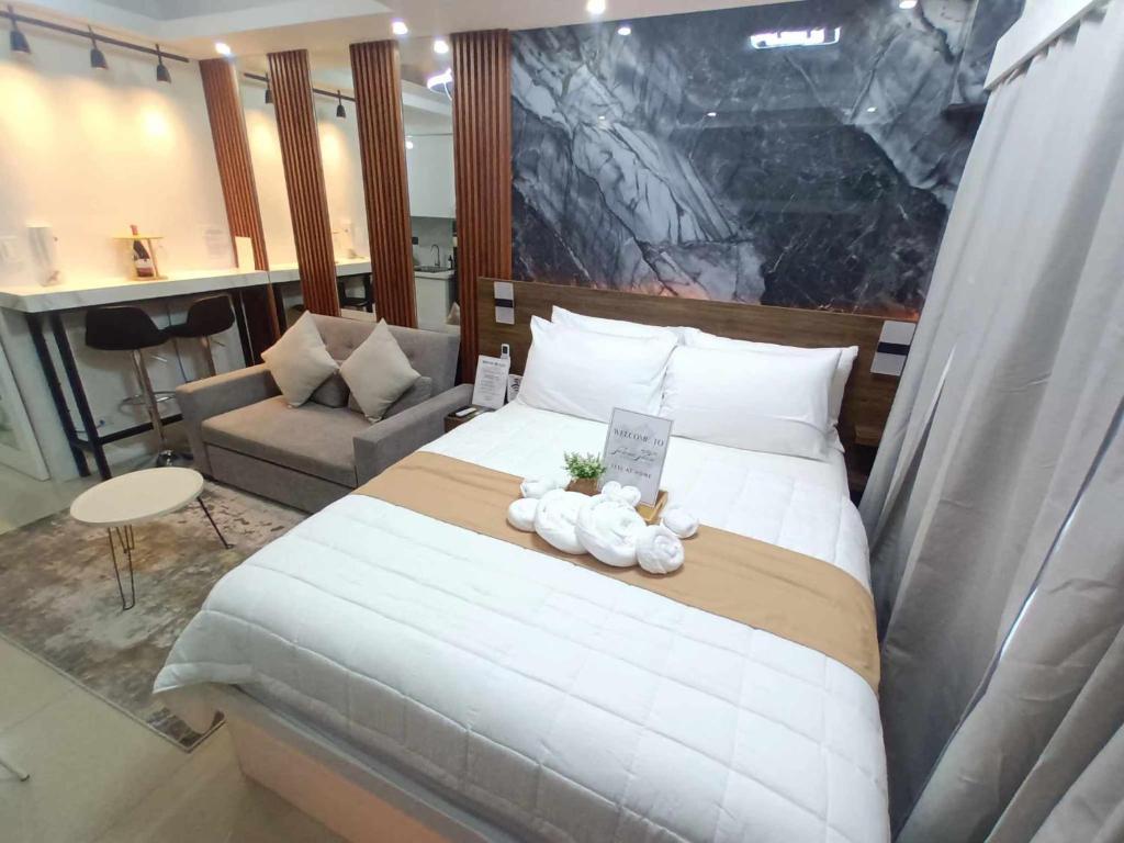 a bedroom with a large bed with two stuffed animals on it at Mitch serene shore in Manila