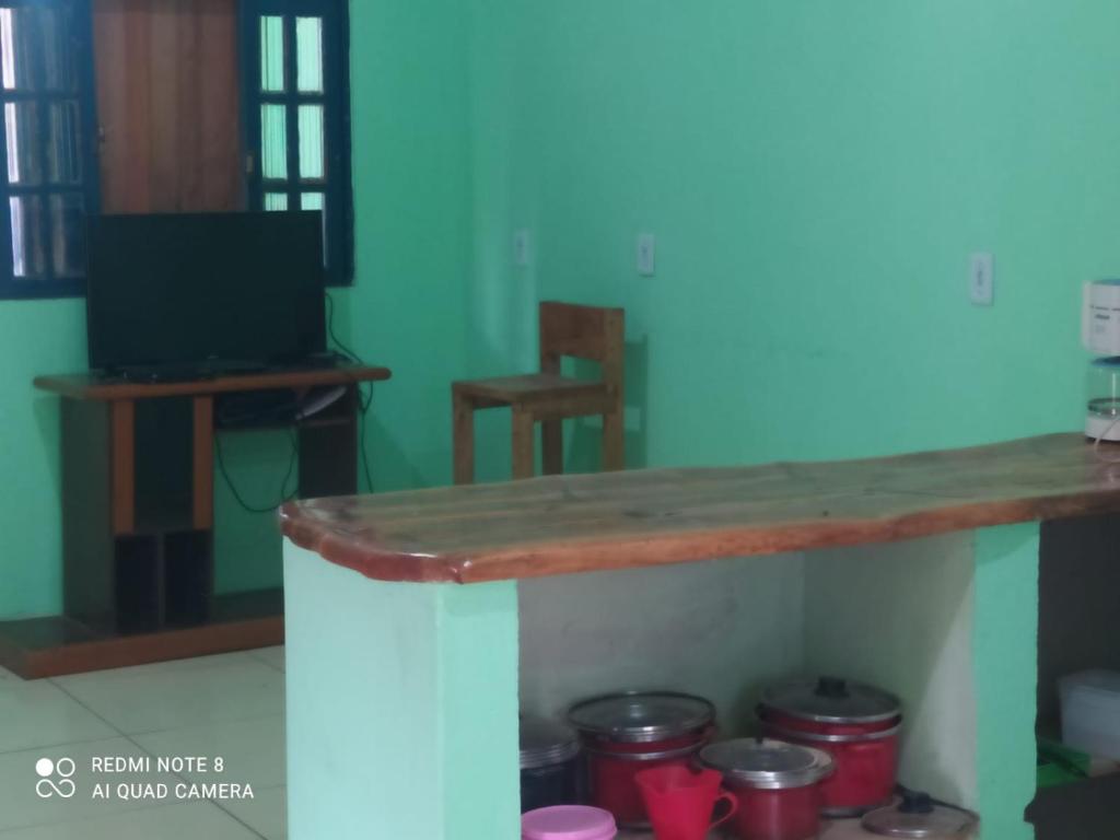 a table with a bunch of pots and pans at Casa Caribe in Cumuruxatiba