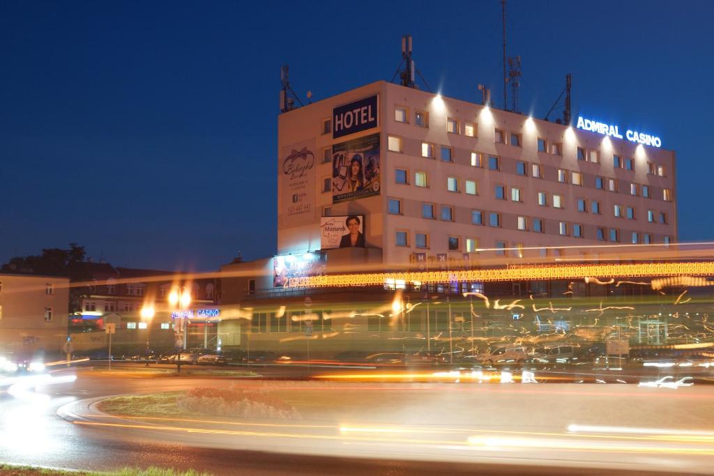 a hotel building with a street in front of it at night at Hotel Kamena in Chełm