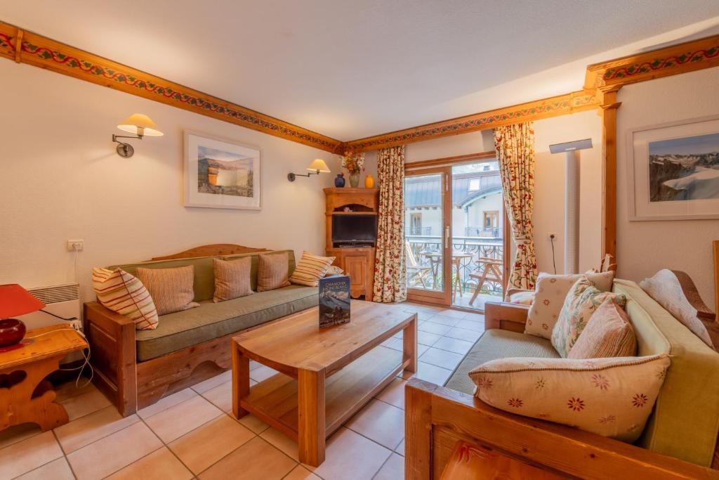 un salon avec deux canapés et une table dans l'établissement Résidence Le Cristal - Mont Blanc 8 - Happy Rentals, à Chamonix-Mont-Blanc